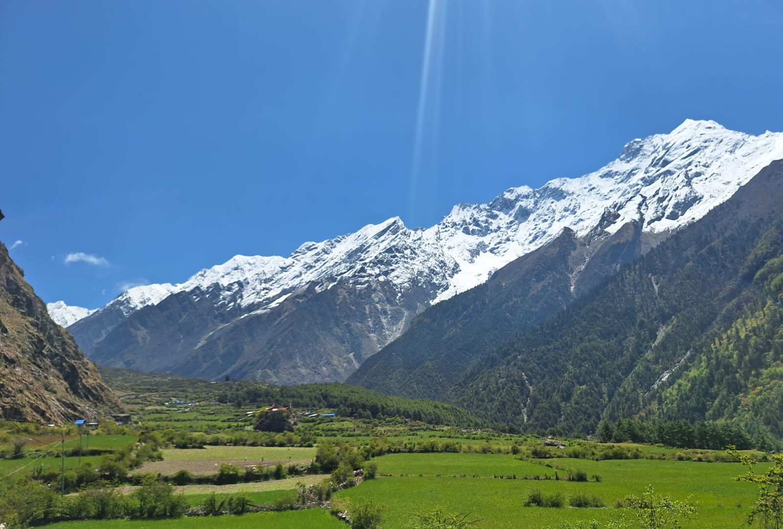 Panoramic view of Tsum Valley showcasing fertile farmlands,